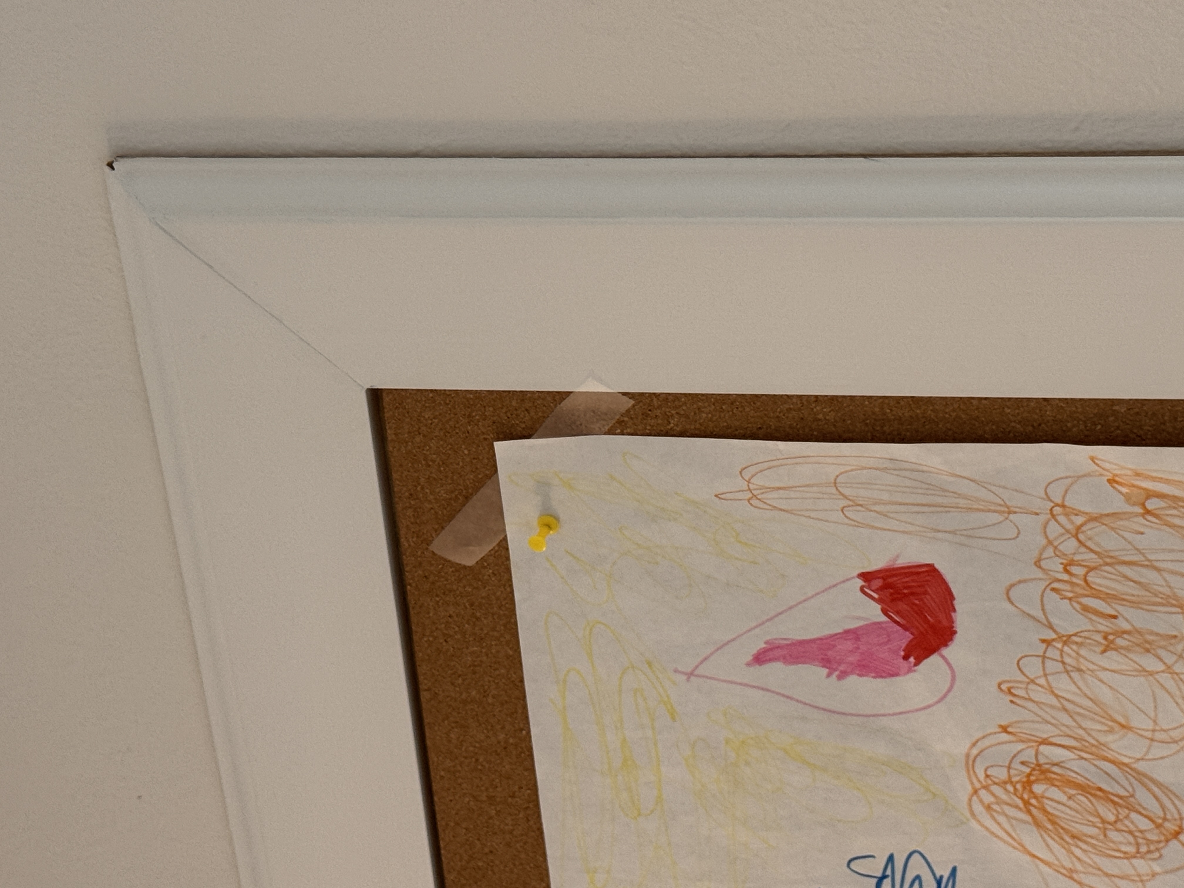 Close-up of the mitered corner and white painted pine frame detail